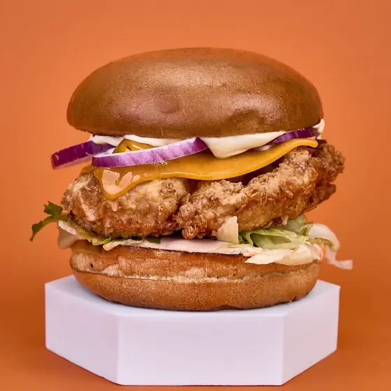 Бургер Classic Chicken с пържено пиле, чедър, айсберг и червен лук в питка бриош